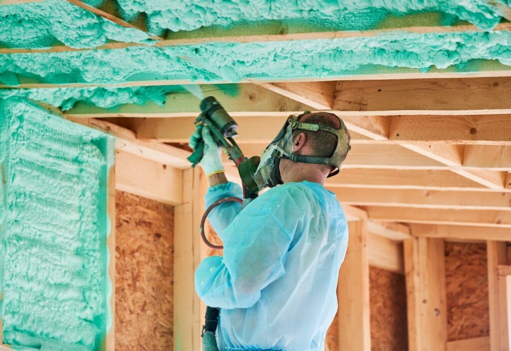 Roofing expert working on spray foam insulation services. - Spray Foam Roofing