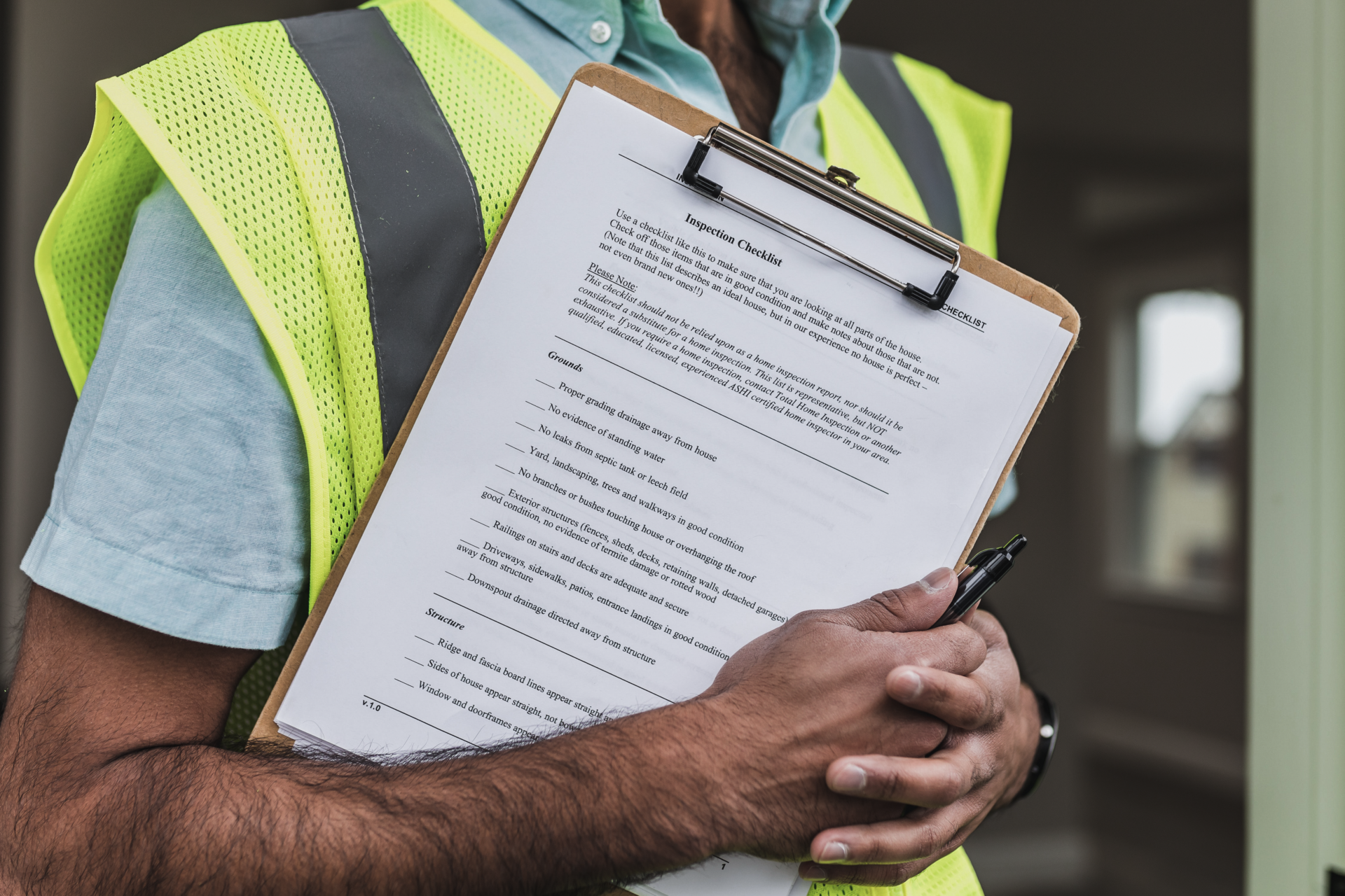 Contractor holding an roofing inspection list clipboard for Commercial Roofing Repairs.