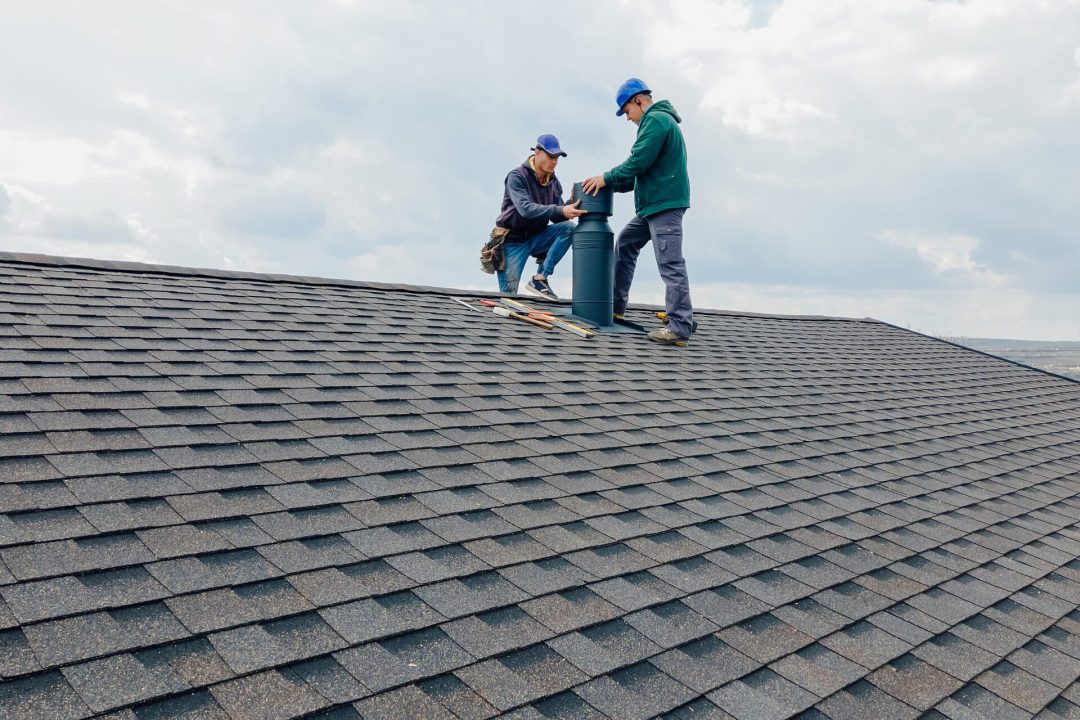 Construction workers Installing chimney and building construction concept. Residential Roofing - Shingle Roof